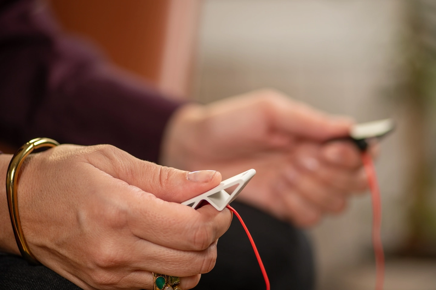 Patient undergoing EMDR therapy using EMDR tappers in their session.